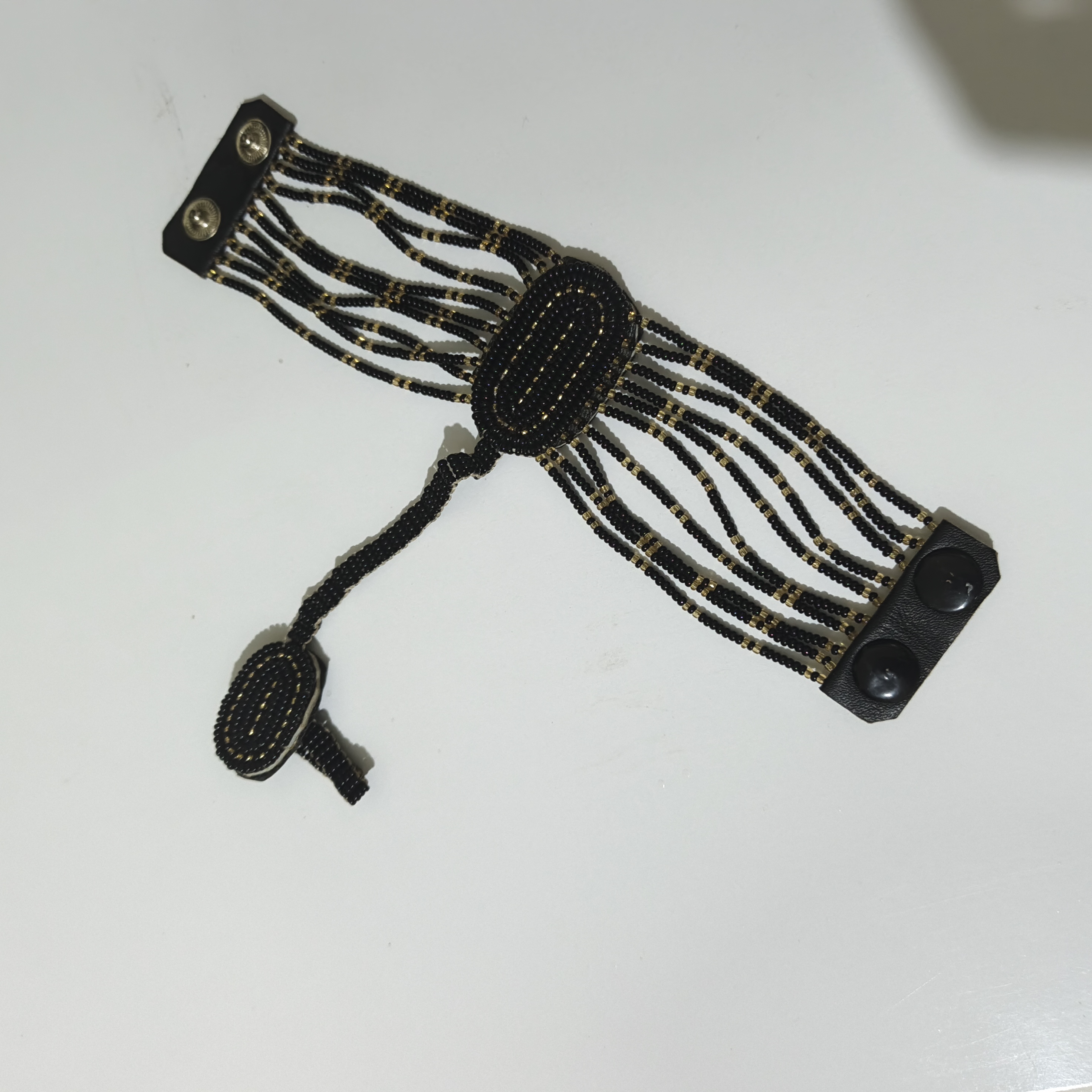 Elevate Your Style with the Black and Gold Hand Harness Bracelet